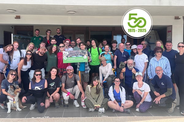 BirdLife Malta staff hold up a large donation check from Robatech for the camera