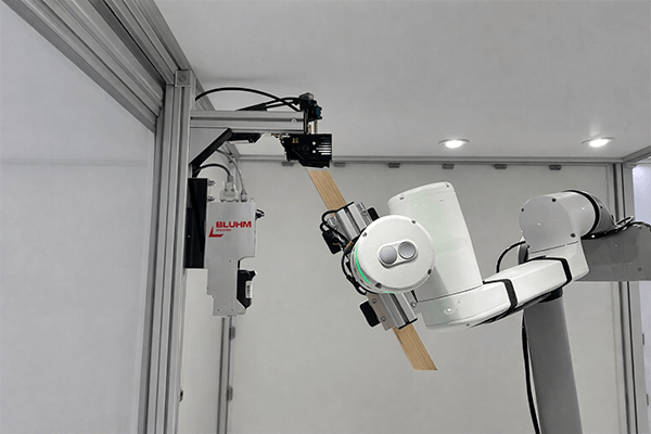 AX application head applies adhesive to wooden strut