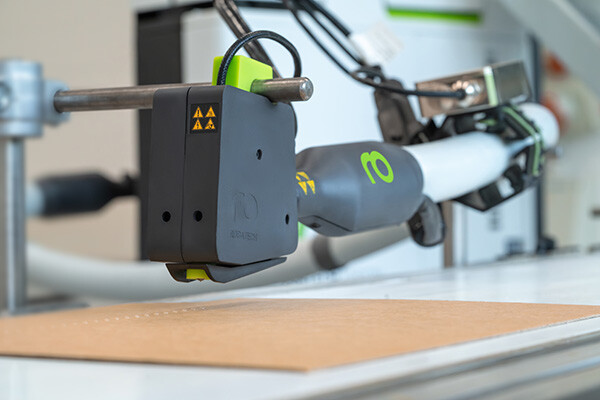 Volta application head with Performa heated hose and control unit, Vision adhesive melter in the background